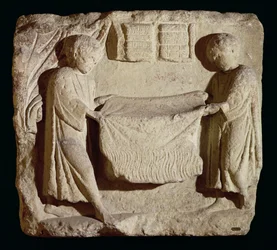 Relief représentant un drapier dans son magasin